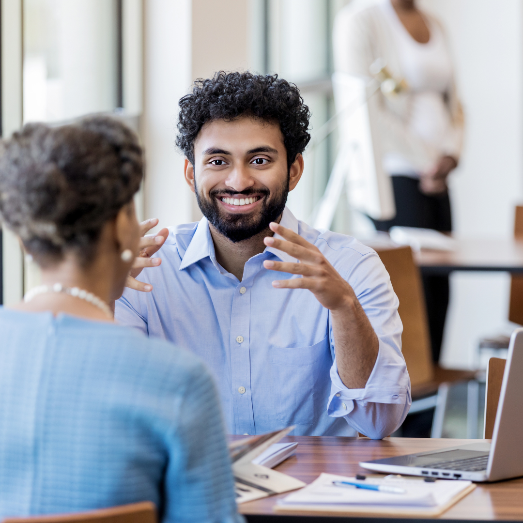 A banking professional helping a woman at his desk